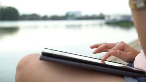 Close up woman hand using digital tablet searching on internet in outdoor nea Stock-Footage 97778803