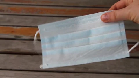 Close-up of woman hand using mask to protect agaist coronavirus. Stock Footage 143936271