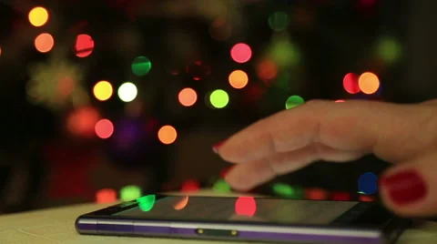 Close up of a woman hand using a smart phone in the night with colorful lights  Stock Footage 57627707