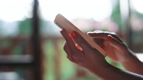 Close up of woman hand using smart phone browsing online enjoying reading social Stock Footage 194571903