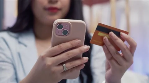 Close up of woman hand using smartphone and credit card for e commerce and .. Stock Footage 344091158