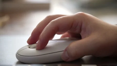 Close-up of a woman hand using white wireless mouse. 스톡 동영상 330279110