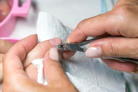 Close up woman hand while process of manicure in nail shop. Beautiful concept Stock Photos