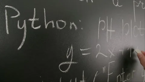 Close up of woman hand writing programming text and formulas on chalkboard Stock Footage 281578113