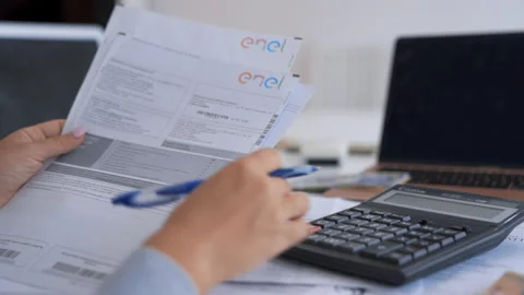 Close up Woman hands checking bills and calculating expenses using calculator. Stock Footage 160190702