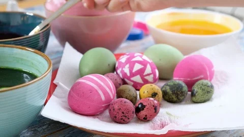 Close up of woman hands coloring easter eggs with egg dye. Colorful easter eggs Stock Footage 122641778