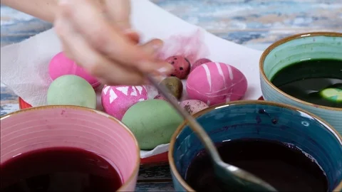 Close up of woman hands coloring easter eggs with egg dye. Colorful easter eggs Stock Footage 123331778