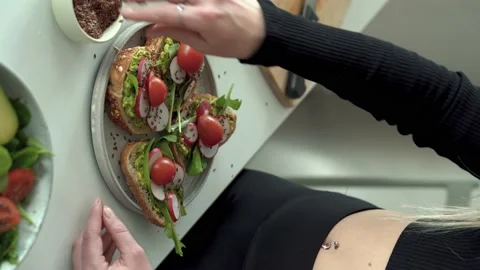 Close-up of woman hands preparing vegetable wtih avocado and tomatoes Stock Footage 190618338
