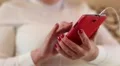 Close up of woman hands with red smartphone HD Footage