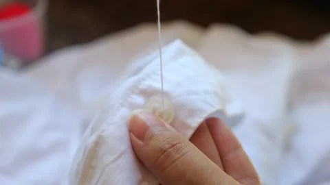 Close up of woman hands sewing a button. Stock Footage 236482736
