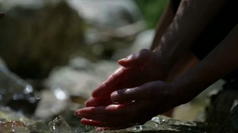 Close-up of a woman hands in slow motion typing in her hands from a stream of 動画素材 157796953