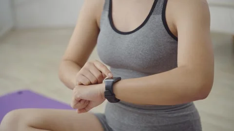 Close Up of Woman Hands Touching Smart Watch Screen to Check Fitness Data after Video stock 341304292