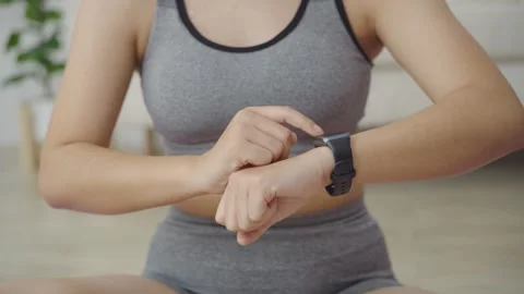 Close Up of Woman Hands Touching Smart Watch Screen to Check Fitness Data after Video stock 341304293