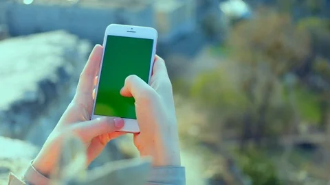 Close up woman hands use smartphone one nature scroll green screen chroma key 5g Stock Footage 112617341