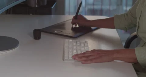 A close-up of a woman hands, using a digital pen and tablet at work. Stock Footage 194531415