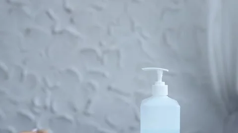 Close-up of woman hands using hand sanitizer gel to prevent spreading virus 스톡 동영상 126971931