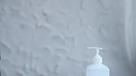 Close-up of woman hands using hand sanitizer gel to prevent spreading virus 스톡 동영상 126971935