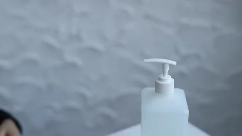 Close-up of woman hands using hand sanitizer gel to prevent spreading virus 스톡 동영상 126971969