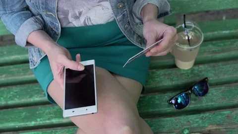 Close up woman hands using mobile smart phone and holding credit card outdoor Stock Footage 80361907