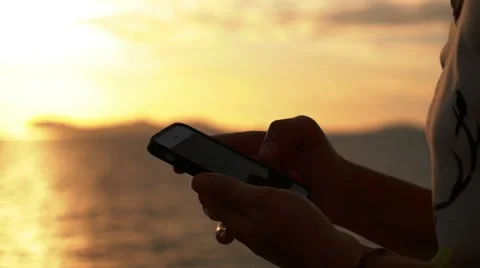 Close up of Woman Hands Using Smart Phone at Sunset. Slow Motion. Video stock 40069870