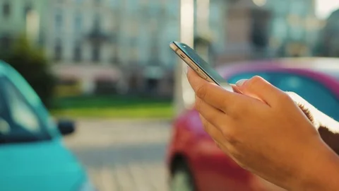 Close up woman hands using smart phone on the city street vackground. Hand Stock Footage