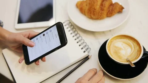 Close up of woman hands using smartphone, scrolling contacts and drinking coffee Video stock 72361745