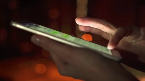 Close-up of woman hands using smartphone touchscreen outdoors in city at night Video stock 84911201