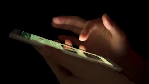 Close-up of woman hands using smartphone touchscreen indoors at night. Browsing Stock Footage 85021945