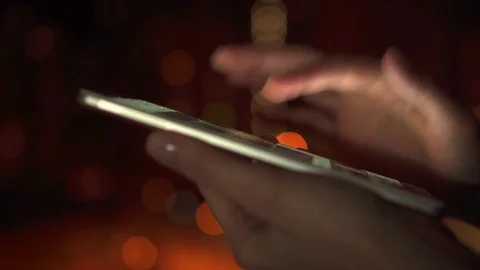 Close-up of woman hands using smartphone touchscreen outdoors in city at night Video stock 85367540