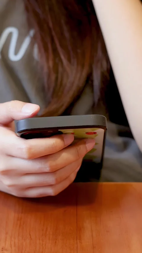 Close Up of Woman Hands Using Smartphone at Wooden Cafe Table Stock Footage 337757269