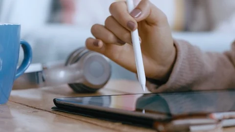 Close up woman hands using tablet computer with stylus pen browsing data Stock Footage 99792170