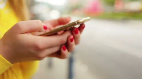 Close-up woman hands using touchscreen phone outdoors in city park Stock Footage 67090648