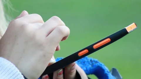 Close-up woman hands using touchscreen phone outdoors in city park Stock Footage 73219307