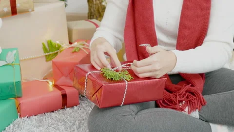Close up woman hands wrap present gift in cozy living room. Woman wrapping chris Video stock 205984835