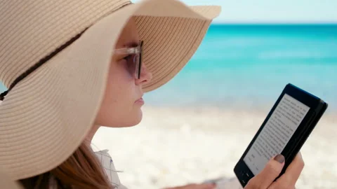Close up of Woman in Hat Reading E-Book on Electronic Reader on Beach at Seaside Stock Footage 155409685