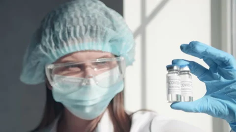 Close-up of a woman holding test tubes with a treatment vaccine Stock Footage 152143653