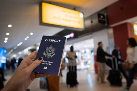 Close up of woman holding an United States passport at the Airport Stock Photos