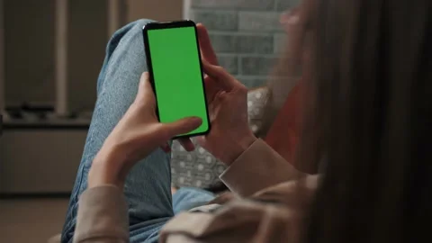 Close up Woman at Home using Smartphone with Green Mock-up Screen, Doing Swiping Stock Footage