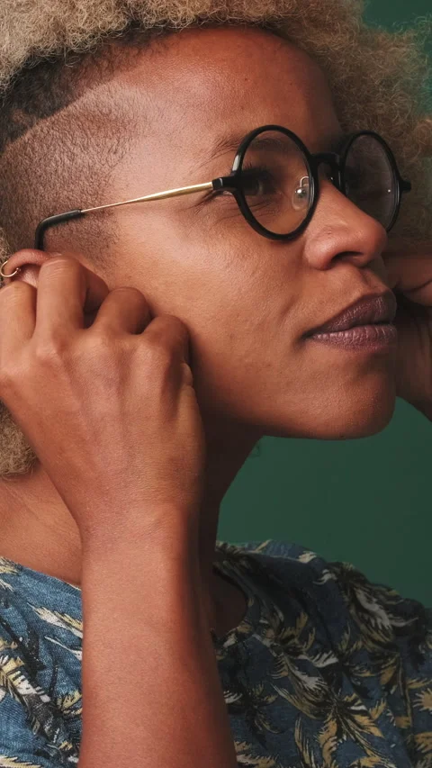 Close-up, woman inserting wireless white headphones into ear, isolated on blue Stock Footage 252504850