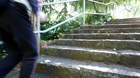Close up woman jogging stairs in Queen Elizabeth park Stock Footage