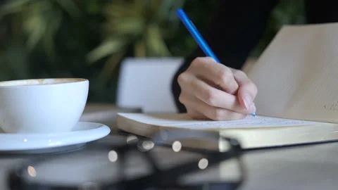 Close-up woman making notes in the diary Stock-Footage 163634657