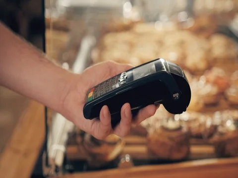 Close-up of woman making payment through NFC in bakery, cafe restaurant, mobile Stock Footage 80493143