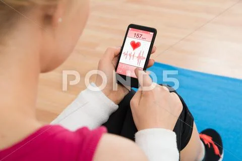 Close-up Of Woman With Mobile Phone Showing Pulse Rate Stock Photos
