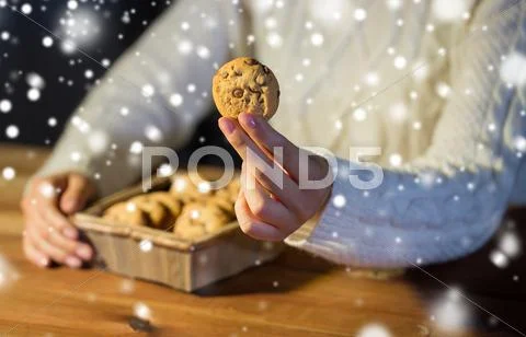 Close up of woman with oat cookies at home Stock Photos