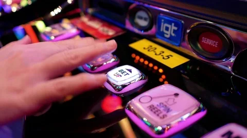Close up woman pressing bet up button on slot machine inside Casino Video stock 85367577