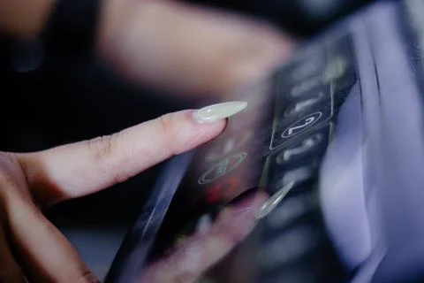 Close-Up of a Woman Pressing a Button on an Elevator Panel Stock Photos