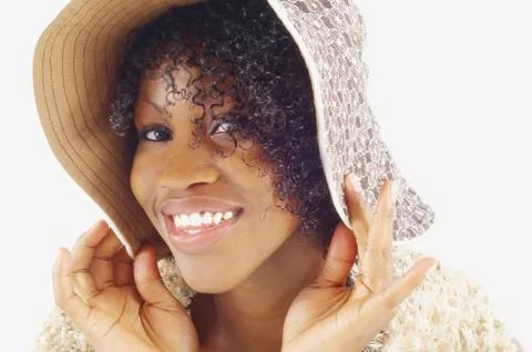 Close up of woman pulling hat down on head Stock Photos