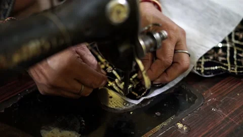 Close-up of woman pulling thread into the needle in sewing machine Stock Footage 205164884