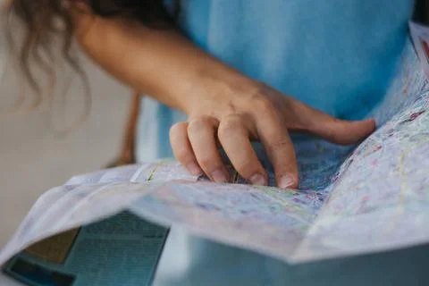 Close-up of woman reading map while on summer holidays Stock Photos