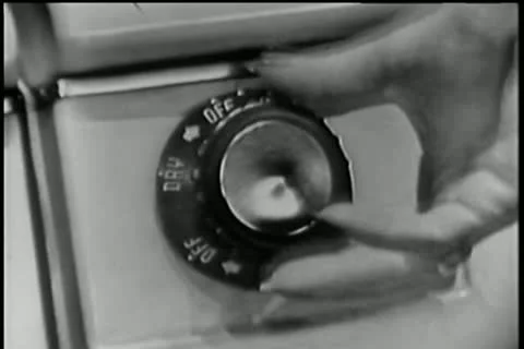 Close-up of woman setting timer on clothes dryer Stock Footage 25208139